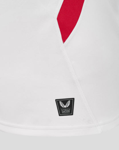 Close-up of V neck on white England rugby shirt with red insert and seam piping with Castore authentication badge visible near hem