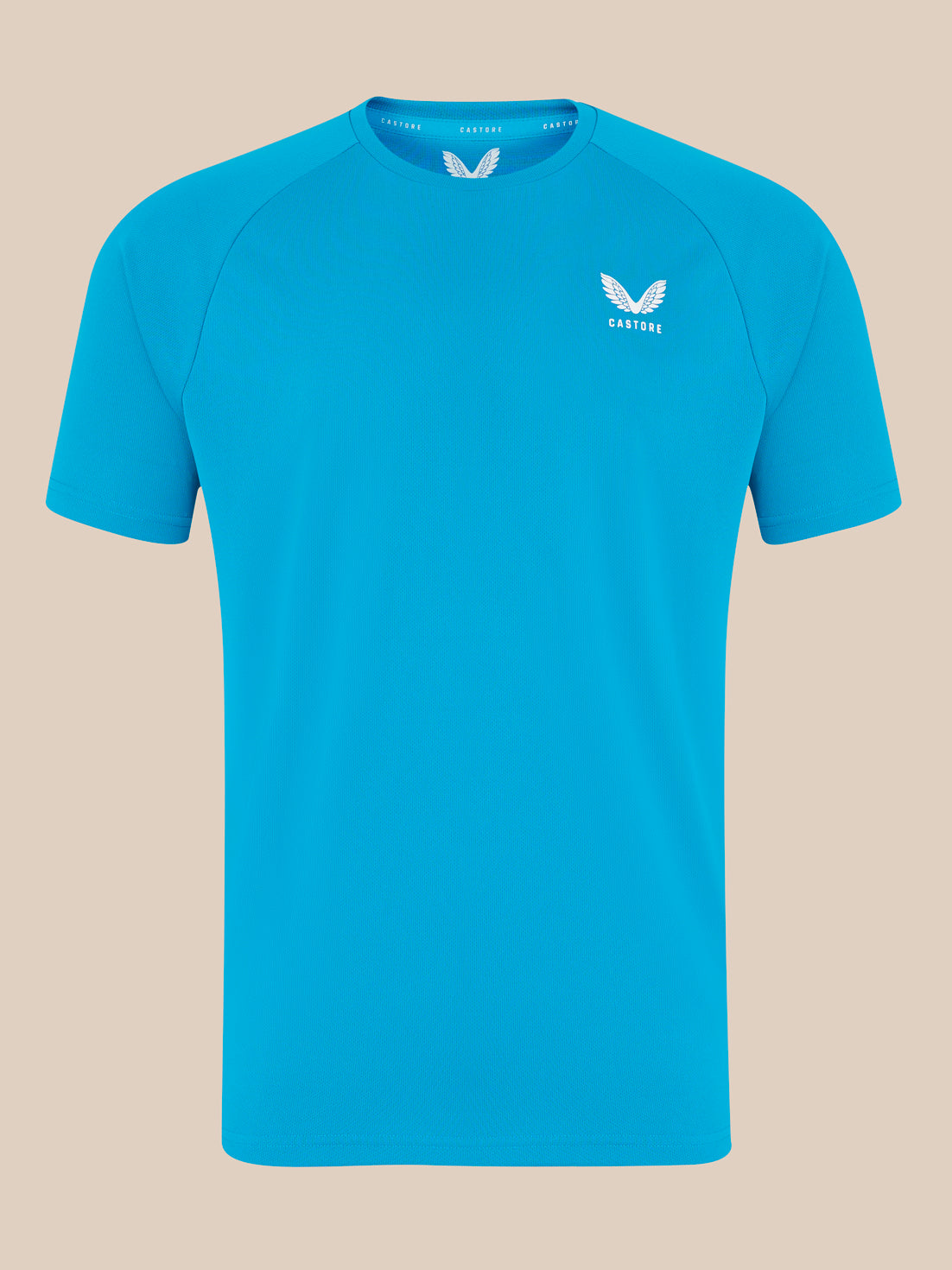 Front view of bright blue Castore logo T shirt with white wing emblem on the left chest.