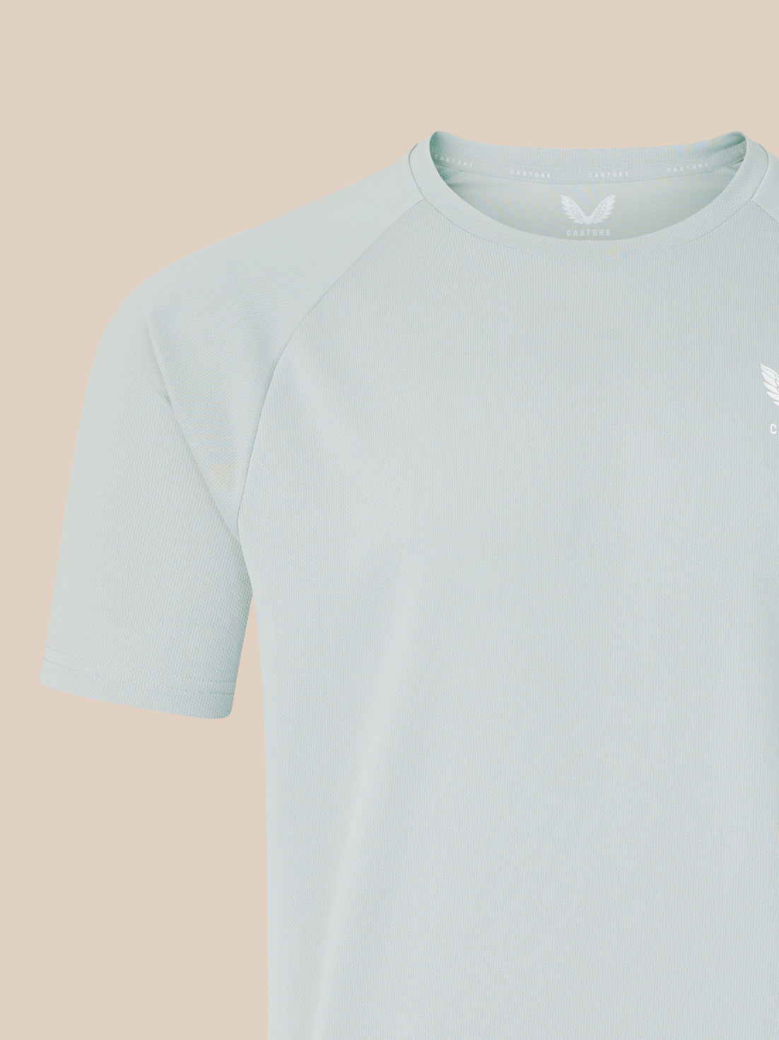 Light grey men's logo T shirt close up of shoulder and neckline showing textured knit fabric.