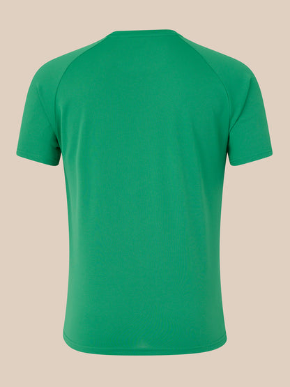 Back view of green men's logo T shirt against a beige background