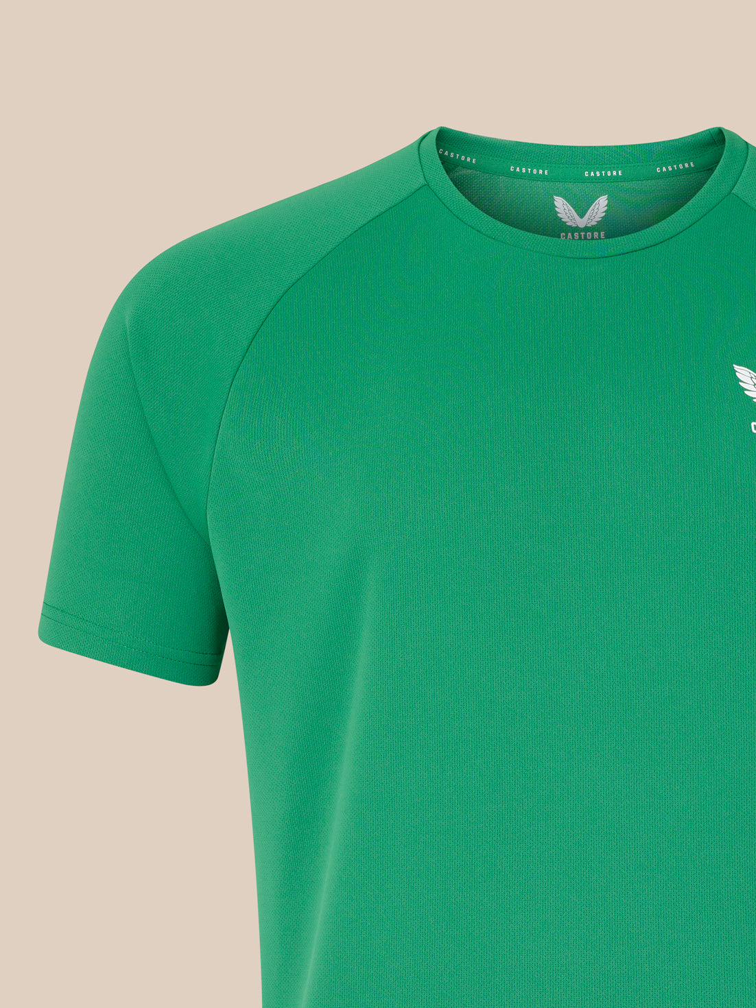 Close up of green crewneck T shirt showing white wing logo on left chest