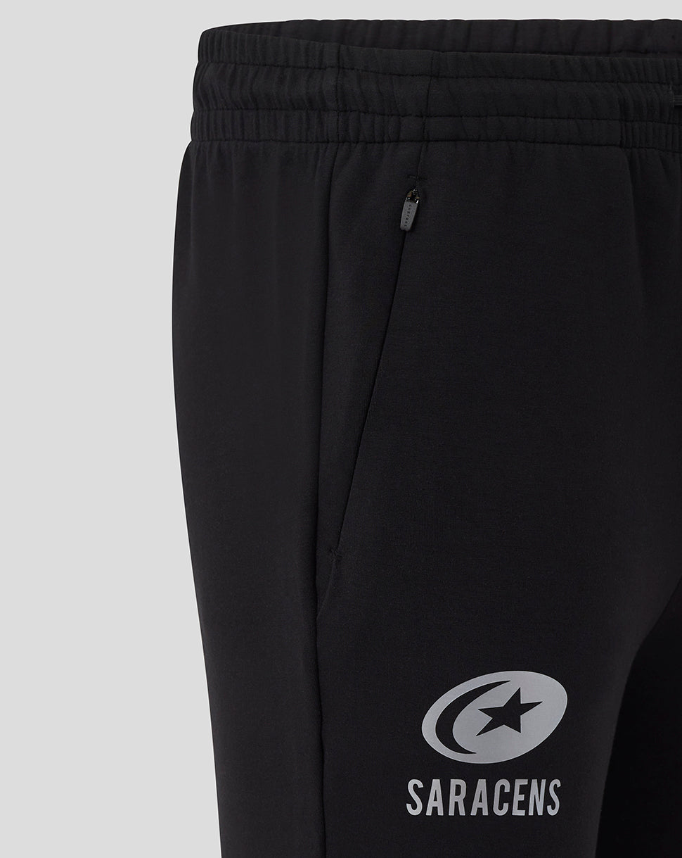 Close up of the elastic waistband and zip side pocket on the black Saracens Travel Knit Pant.