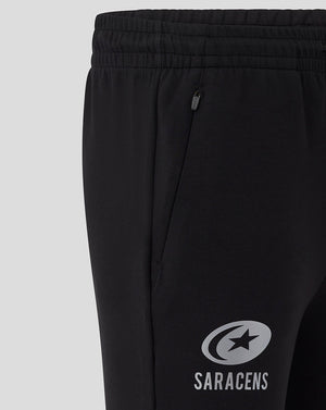 Close up of the elastic waistband and zip side pocket on the black Saracens Travel Knit Pant.