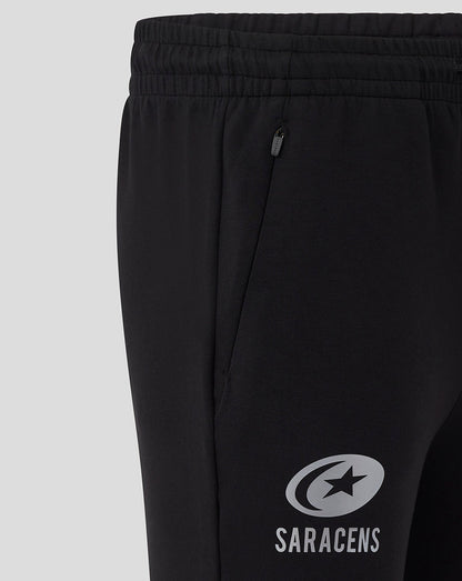 Close up of the elastic waistband and zip side pocket on the black Saracens Travel Knit Pant.