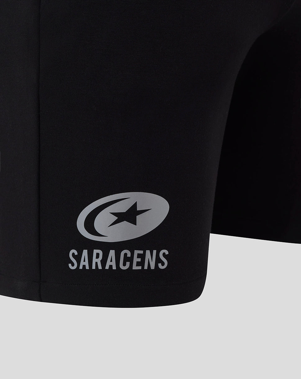 Saracens logo and name on the leg of black travel shorts