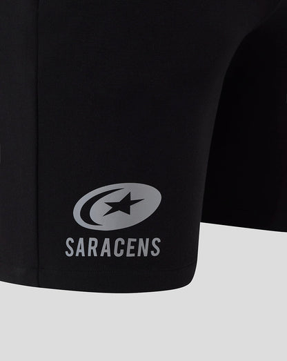 Saracens logo and name on the leg of black travel shorts
