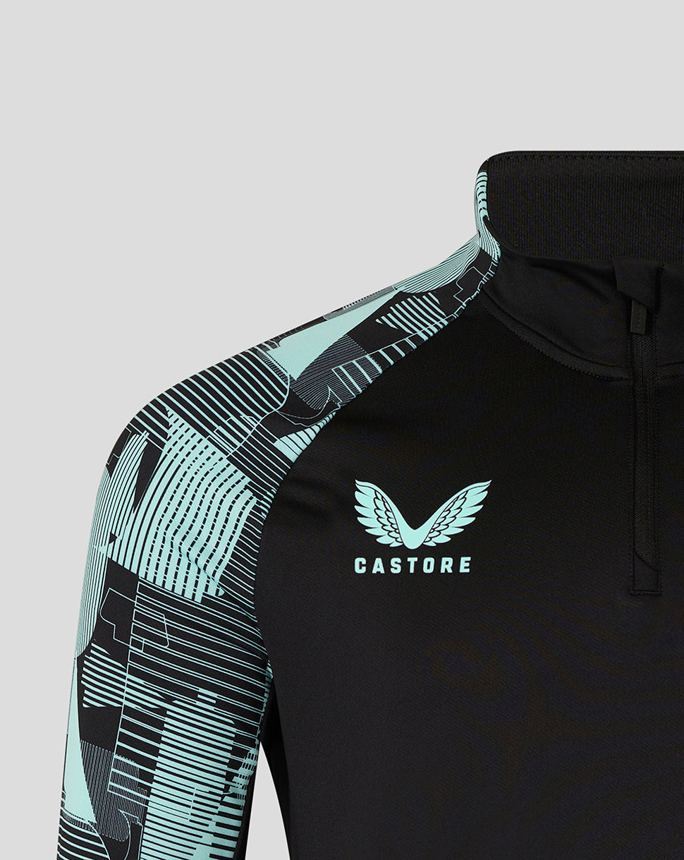 Close-up of Castore logo on black front with teal patterned sleeve of the England Ashes junior training top.