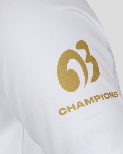 White jersey fabric with a small red 2003 patch near the hem