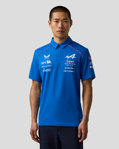 Male model wearing blue BWT Alpine Formula One Team Polo Shirt with team logos on the chest and sleeves.