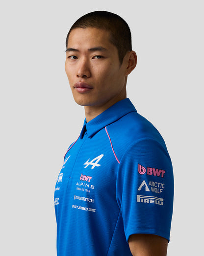 Close-up of a male model wearing the blue Official Men’s BWT Alpine polo shirt with sponsor logos on the chest.