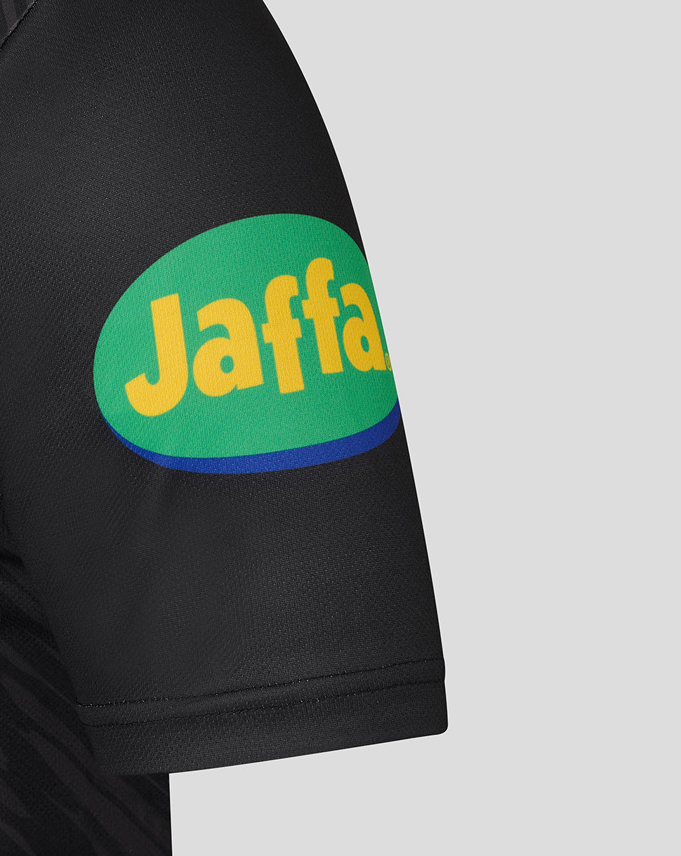 Sleeve close up showing round Jaffa sponsor patch in green and yellow on black jersey