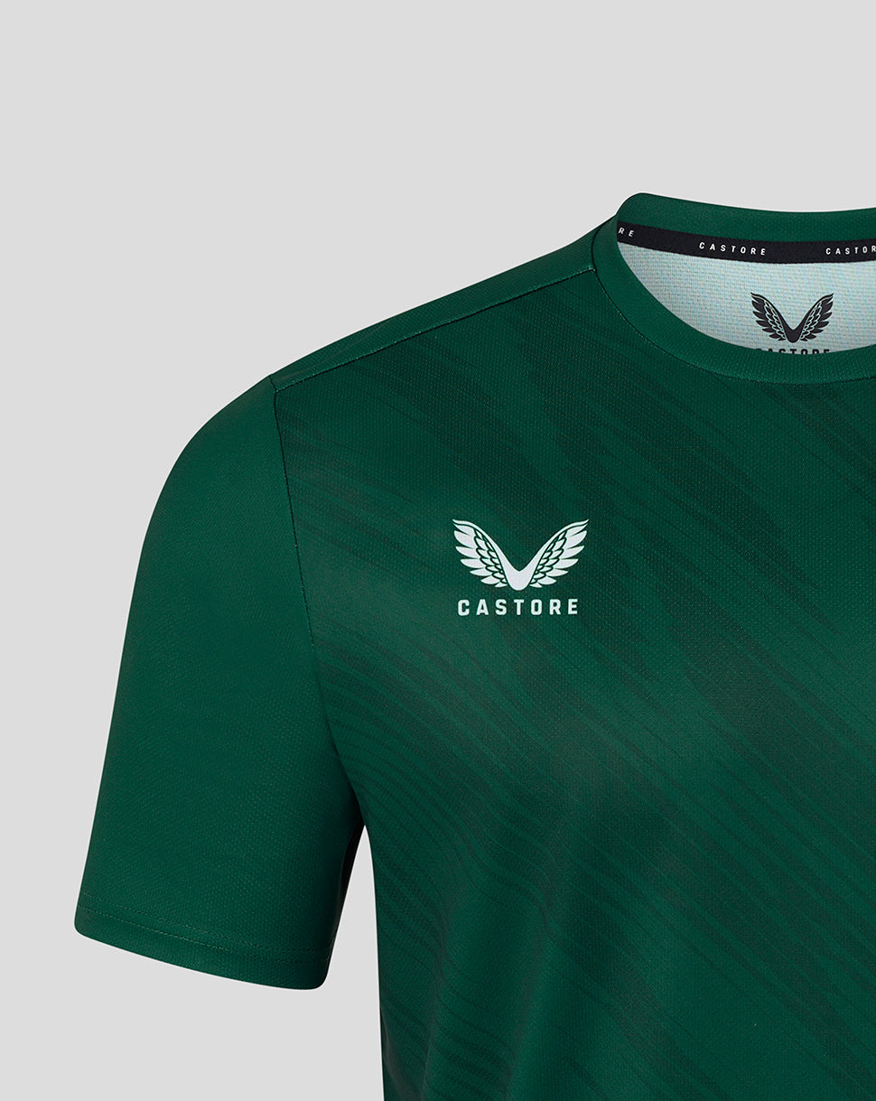 Close up of dark green warm up T shirt showing Castore logo on chest and collar interior label
