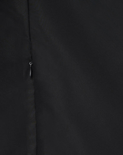 Close up of black jacket front showing a vertical zipper and smooth fabric