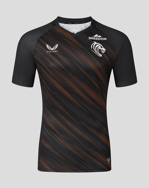 Front view of Leicester Tigers Men's 25/26 Warm Up Jersey in black with orange diagonal pattern and Breedon sponsor