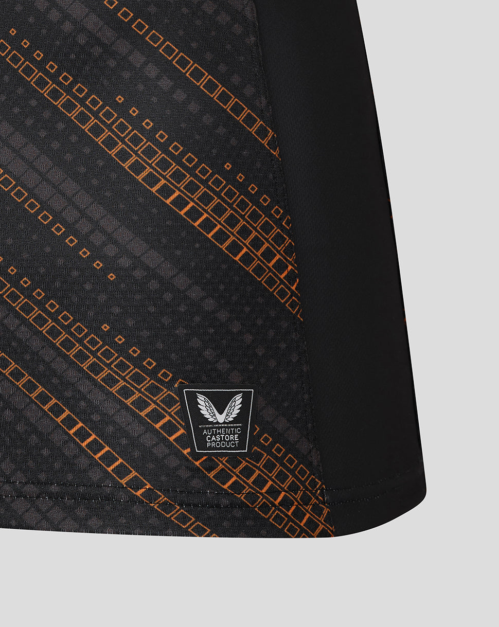 Lower front panel of black Leicester Tigers warm up jersey with orange pattern and authentic Castore product badge.