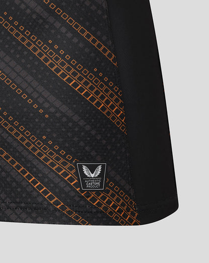 Lower front panel of black Leicester Tigers warm up jersey with orange pattern and authentic Castore product badge.