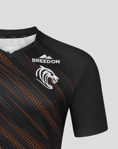 Leicester Tigers black warm up jersey close-up with the BREEDON logo and diagonal orange pattern.