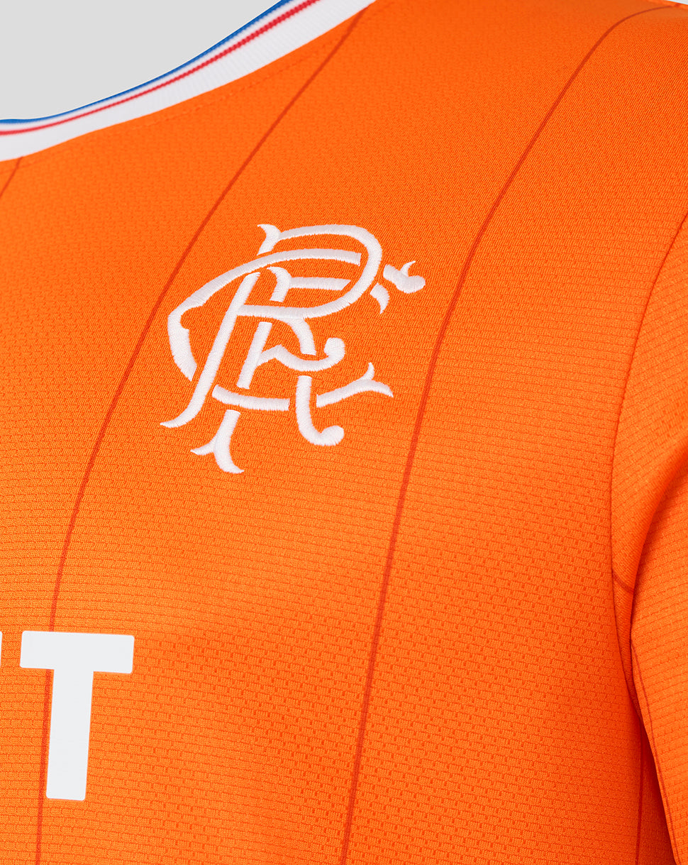 Close up of the Rangers crest embroidered on orange Fourth Shirt fabric