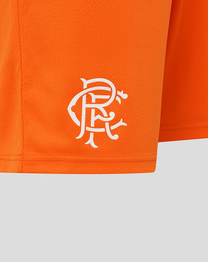 Close up of orange Rangers juniors shorts showing the white crest on the left leg near the hem