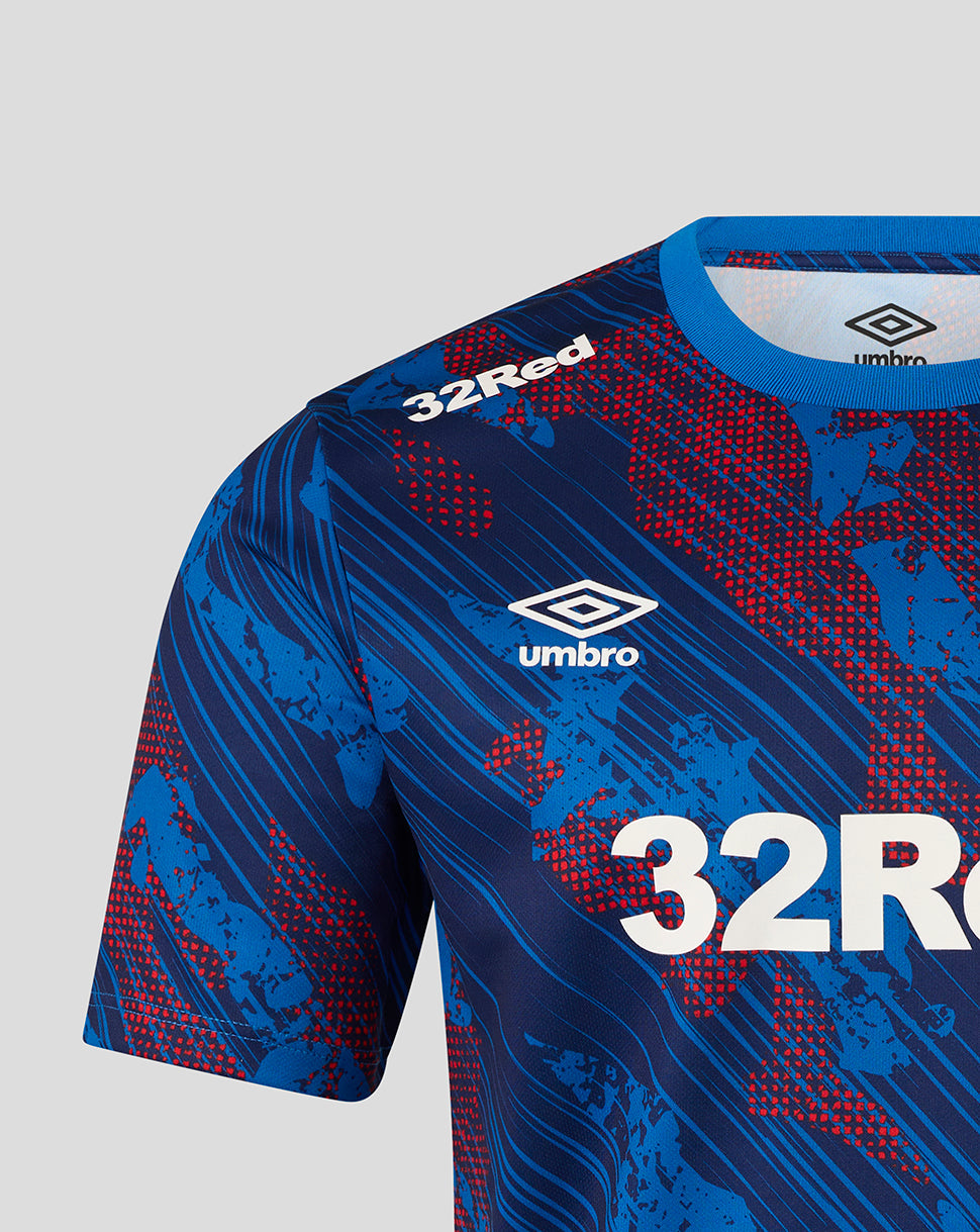 Blue sports jersey with red patterns and '32Red' branding on a light gray background