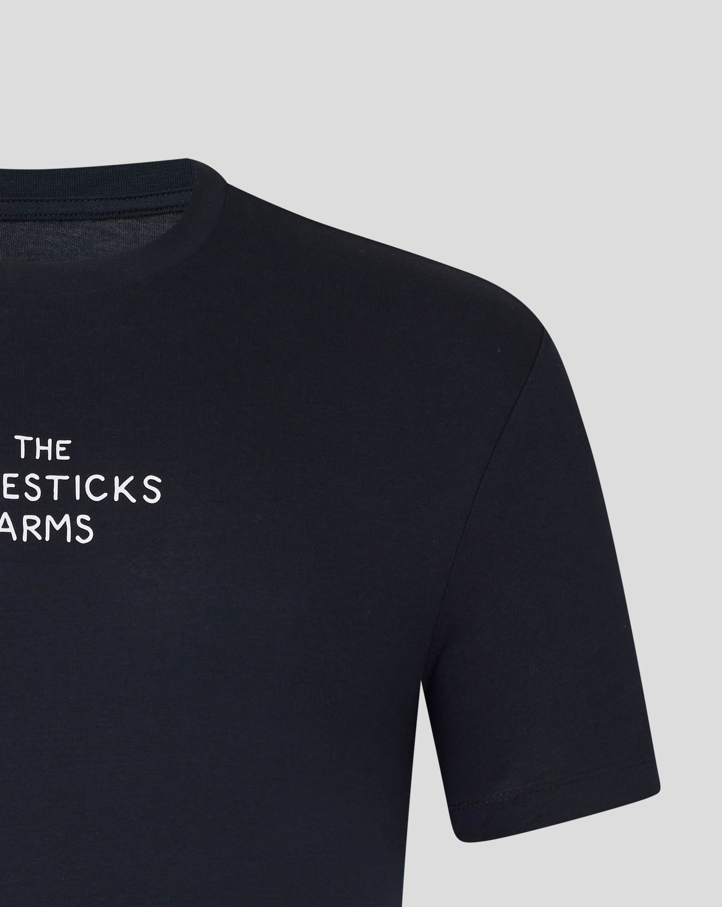 Close up of navy tee neckline and shoulder showing partial white print The Majesticks Arms