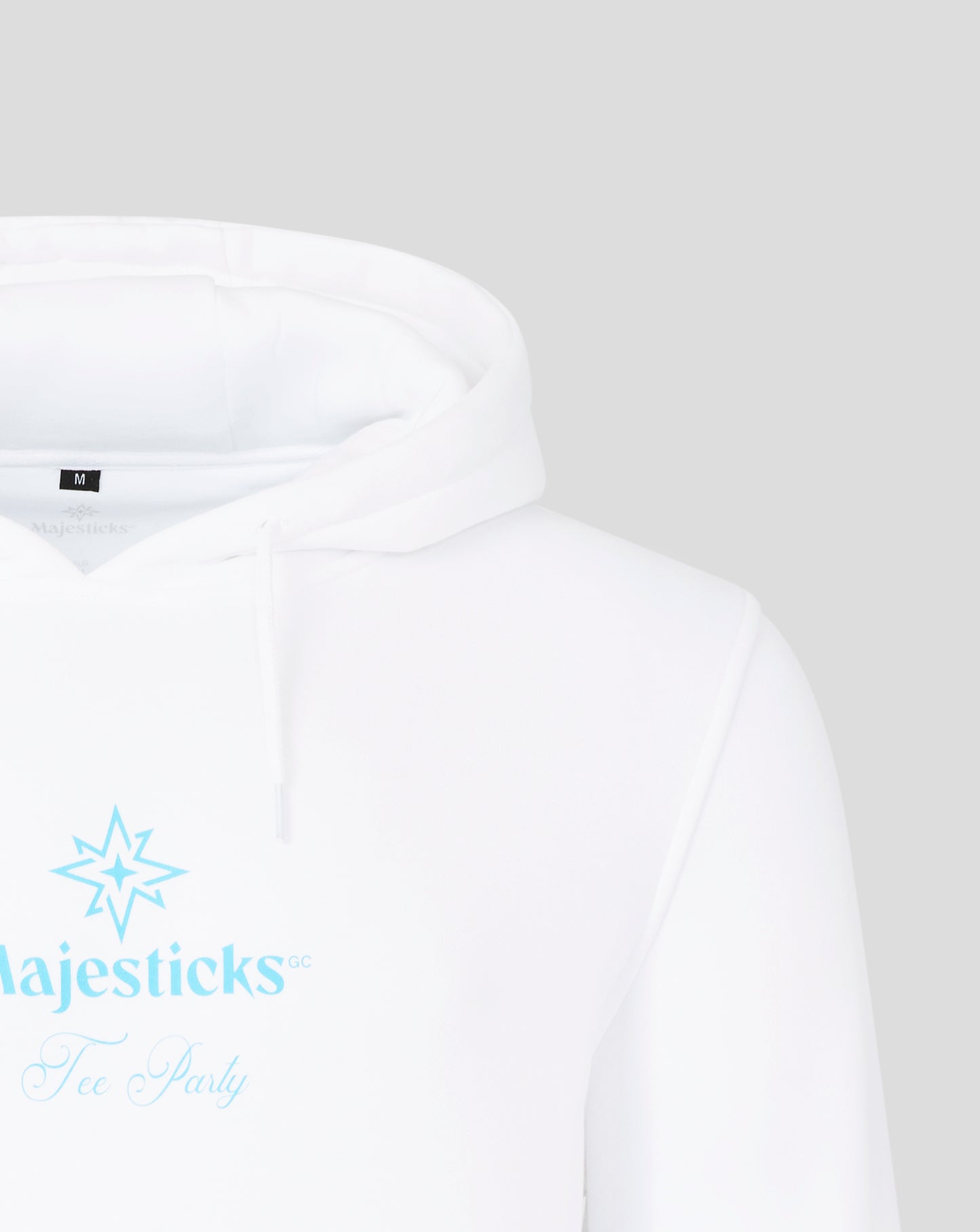 Close up of white Majesticks hoodie hood with size M tag at the neck and a faint interior logo