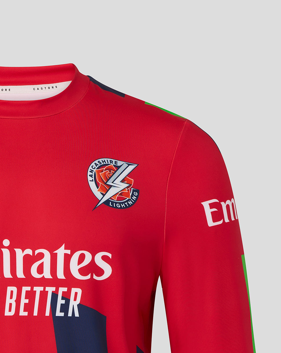 Shoulder and chest close-up of the red Lancashire Cricket sweatshirt showing the crest and Emirates branding on the sleeve.