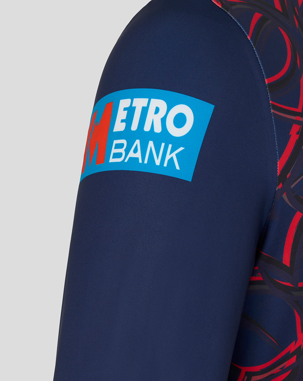 Close-up of navy sweatshirt sleeve with bright blue Metro Bank patch.