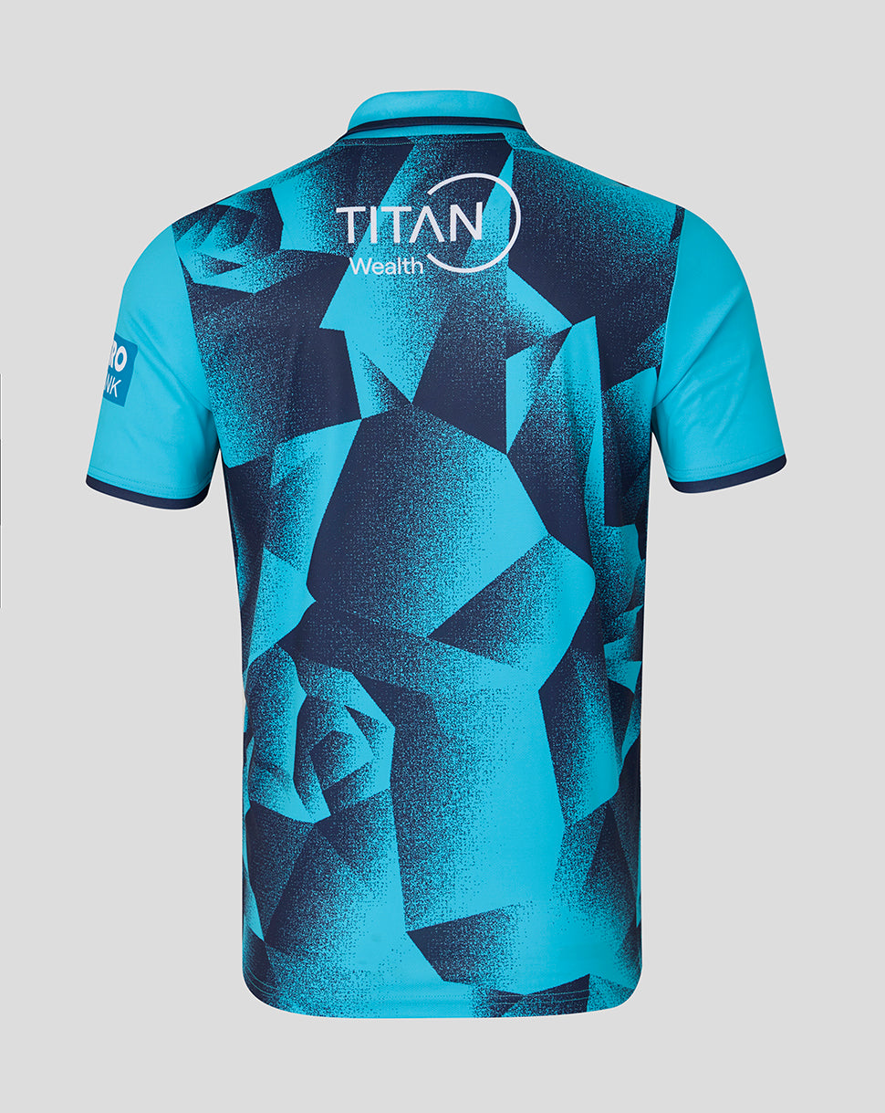 Blue sports jersey with geometric pattern and Titan Wealth logo on a gray background