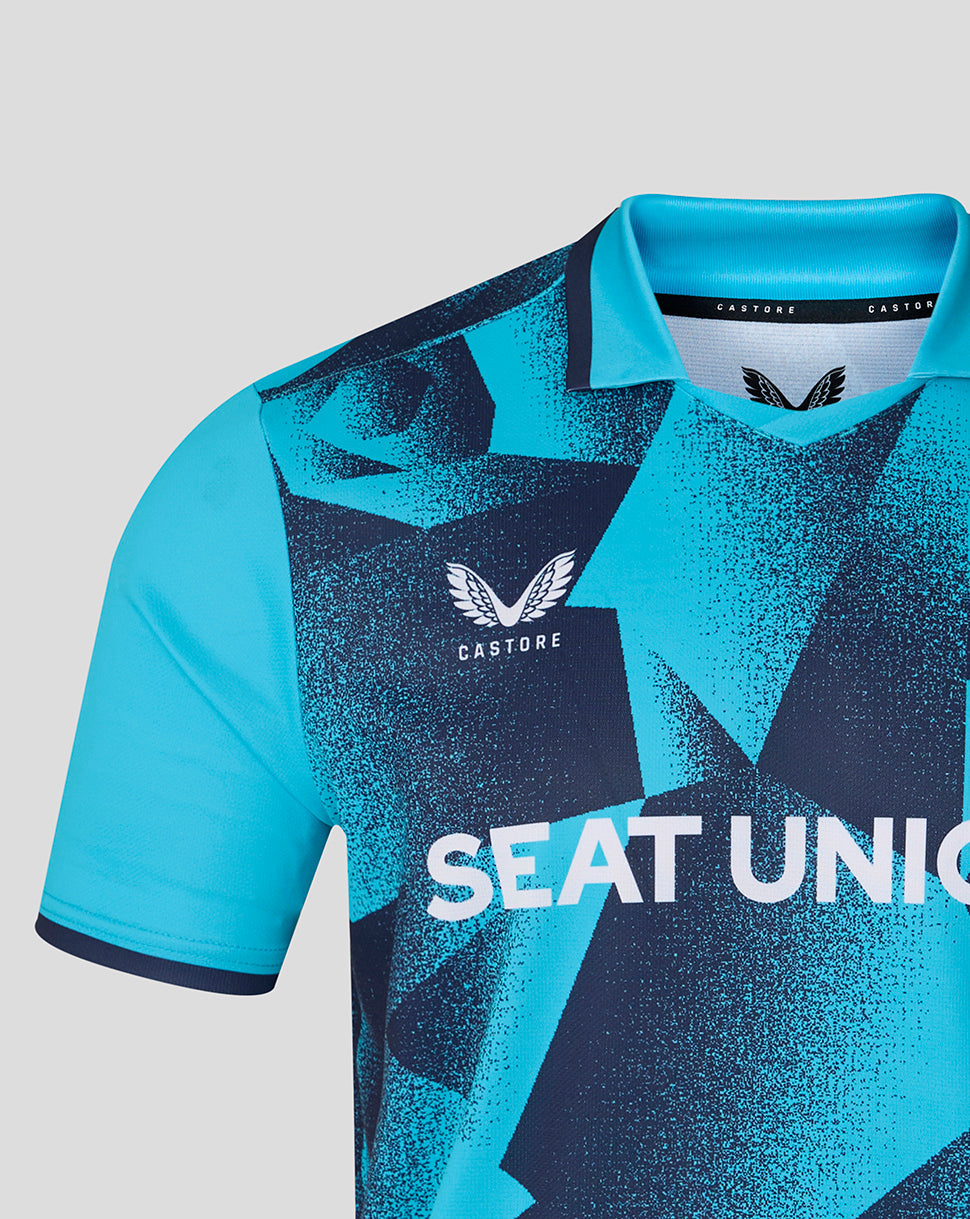 Blue sports jersey with geometric patterns and visible branding on a light gray background