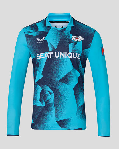Blue sports jersey with geometric pattern and visible branding on a gray background
