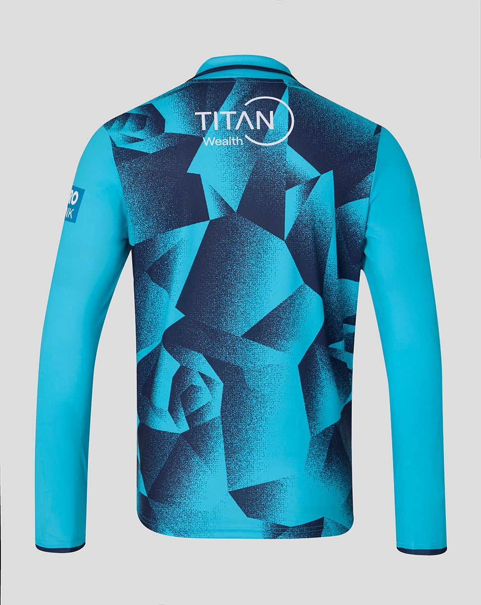 Blue sports jersey with geometric pattern and Titan Wealth logo on a gray background