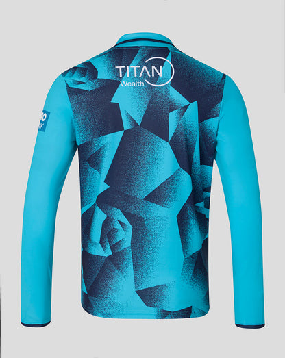 Blue sports jersey with geometric pattern and Titan Wealth logo on a gray background