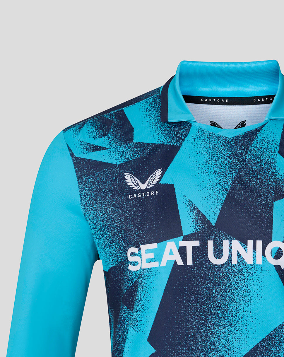 Blue sports jersey with geometric pattern and visible branding on a light gray background