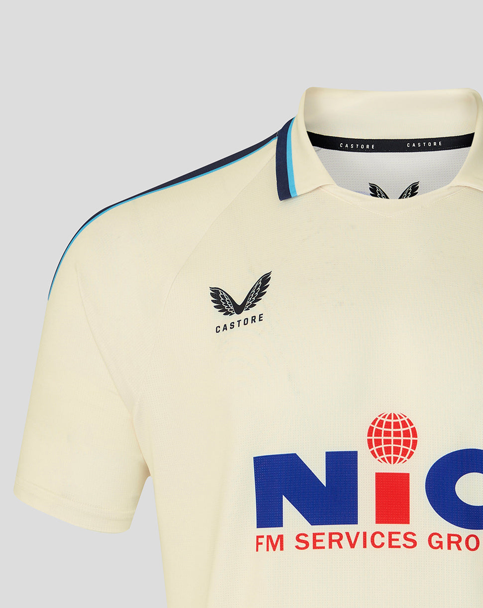 Cream Yorkshire CCC jersey close up showing crest on chest, collar detail, and NIC sponsor graphic.