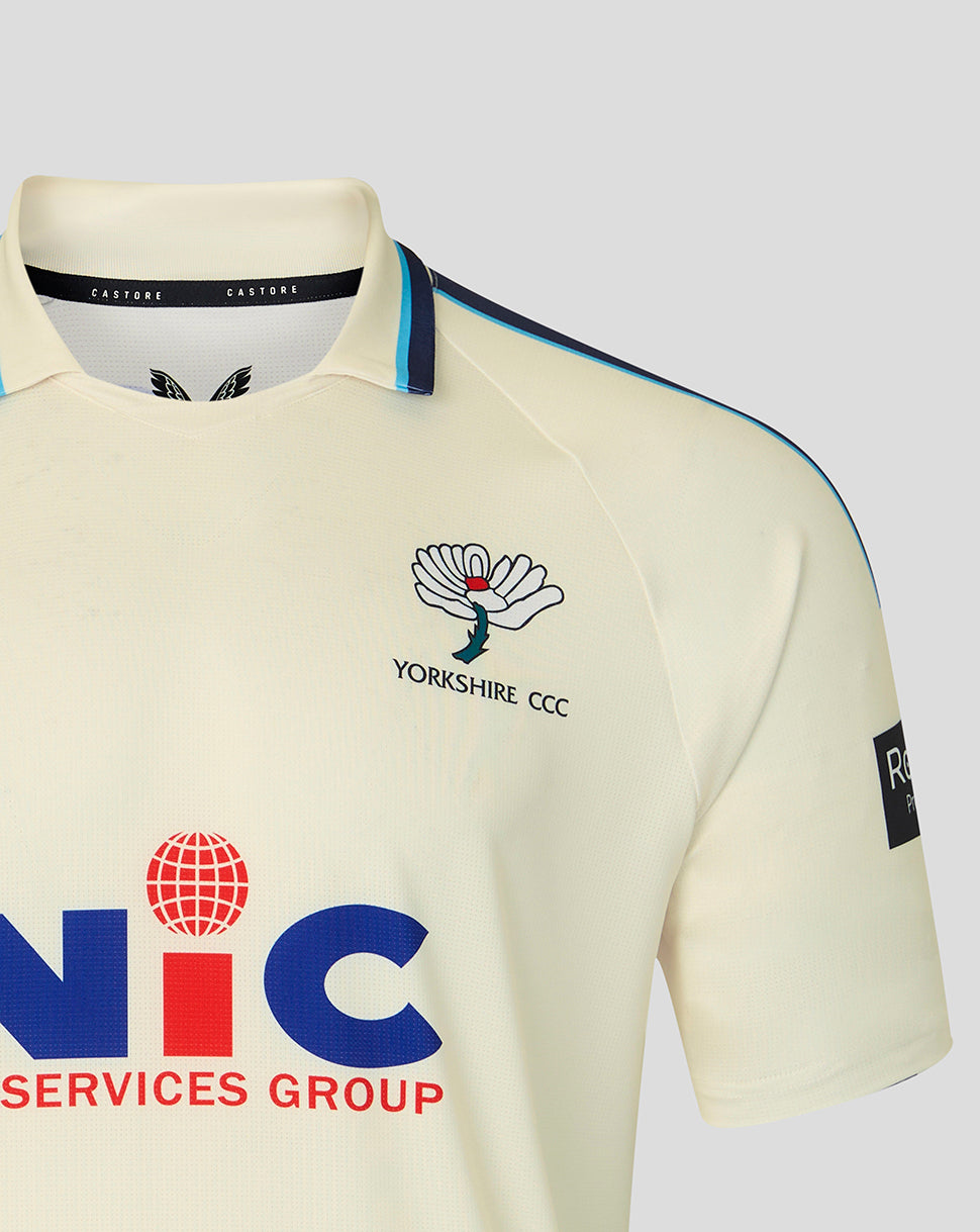 Cream Yorkshire CCC jersey front close up featuring crest on left chest and NIC sponsor with navy trim.