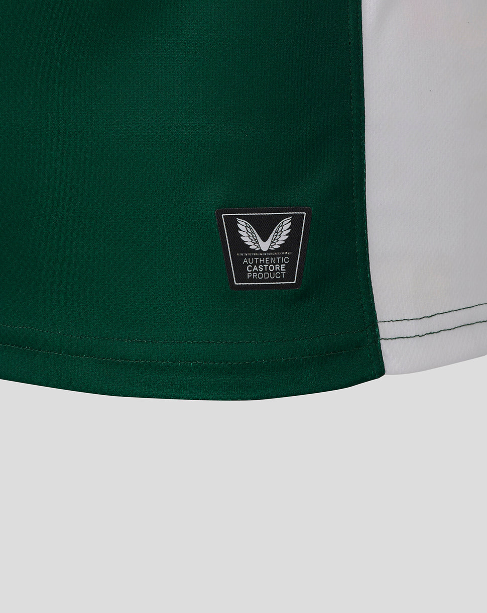 Close up of green fabric on the jersey hem with a small authentic Castore product patch
