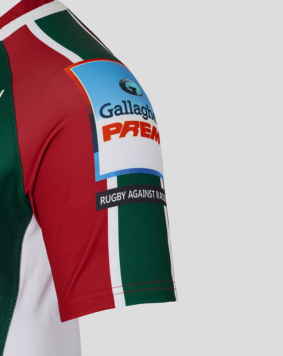 Close up of Leicester Tigers junior home shirt sleeve with red and green panels a Gallagher Premiership patch and Rugby Against Racism band