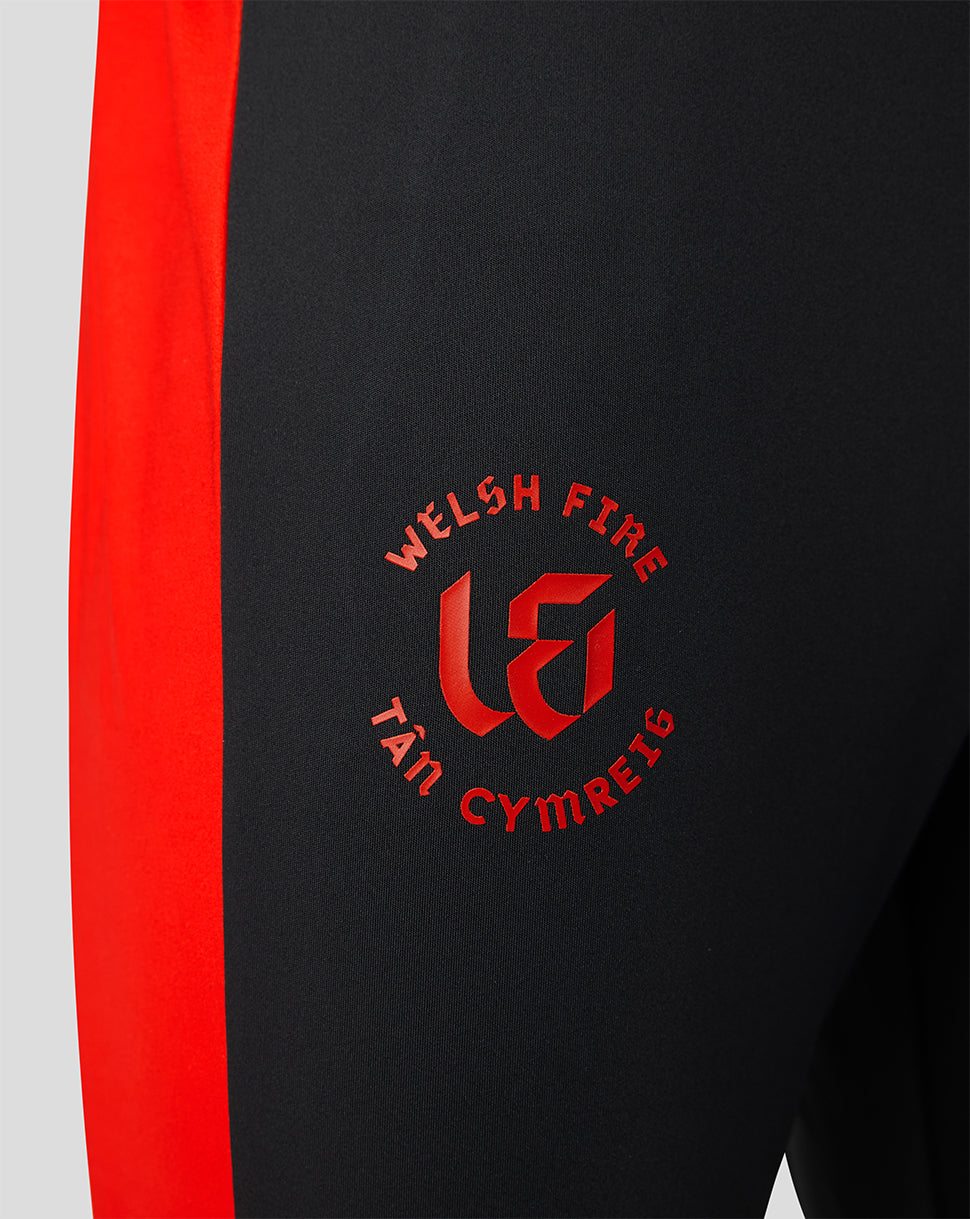 Close up of black pant with red side panel and Welsh Fire crest on thigh