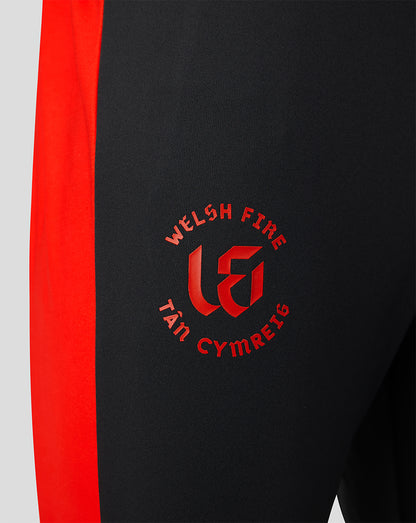 Close up of black pant with red side panel and Welsh Fire crest on thigh
