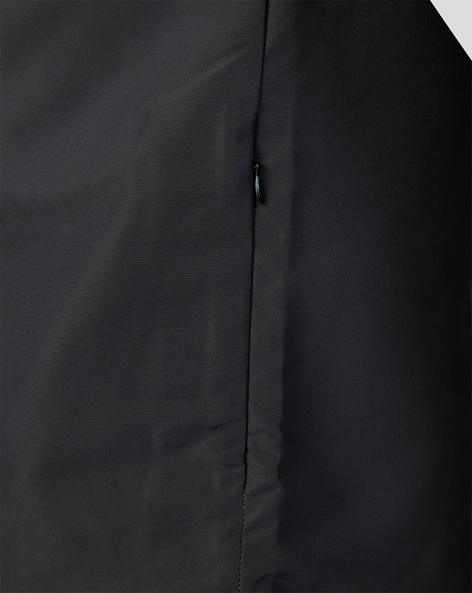 Close up of the zip and seam on a dark Welsh Fire woven pre match jacket