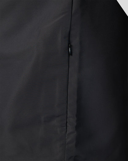 Close up of the zip and seam on a dark Welsh Fire woven pre match jacket
