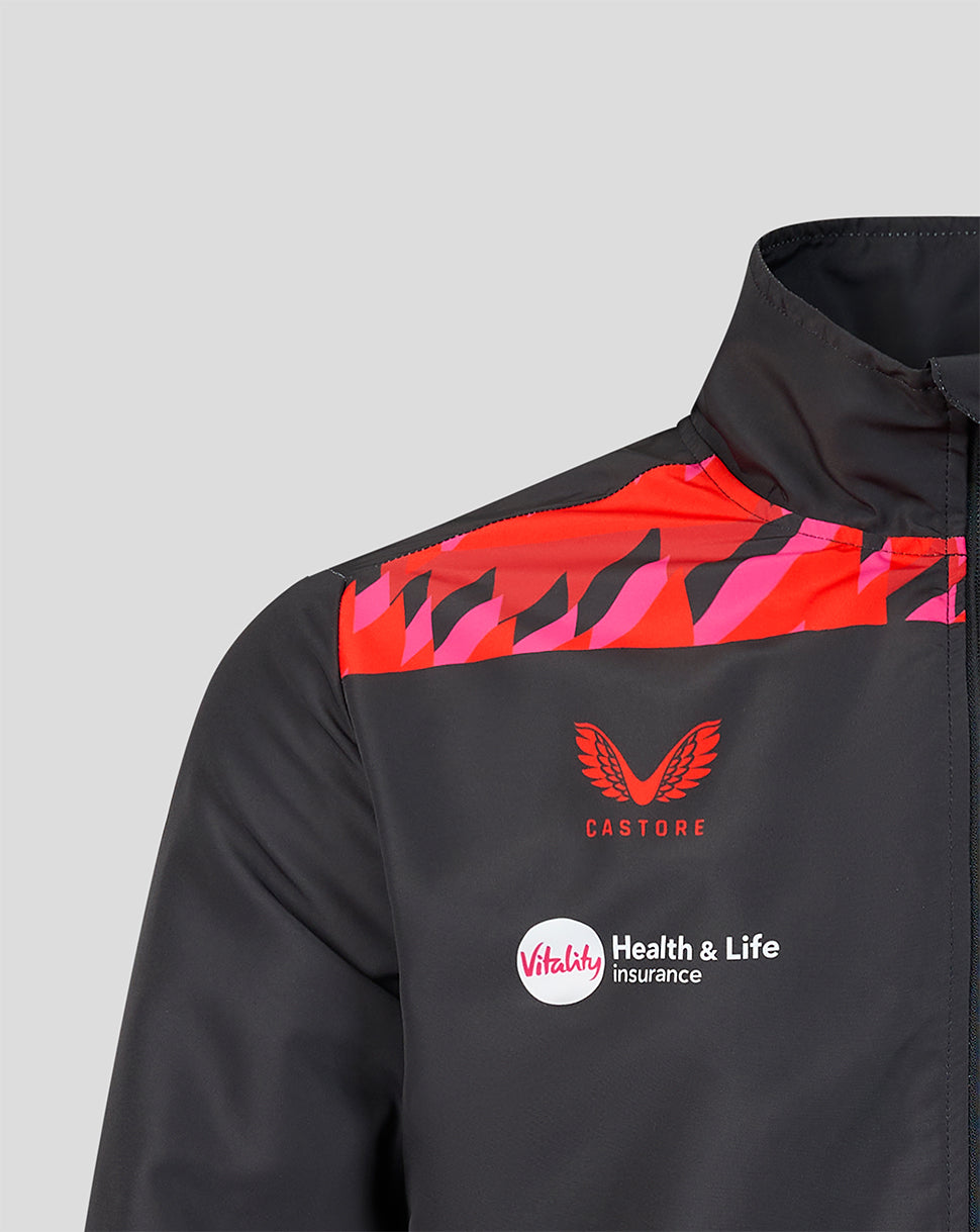 Shoulder detail of a black Castore jacket with red pink pattern crest and Vitality sponsor logo