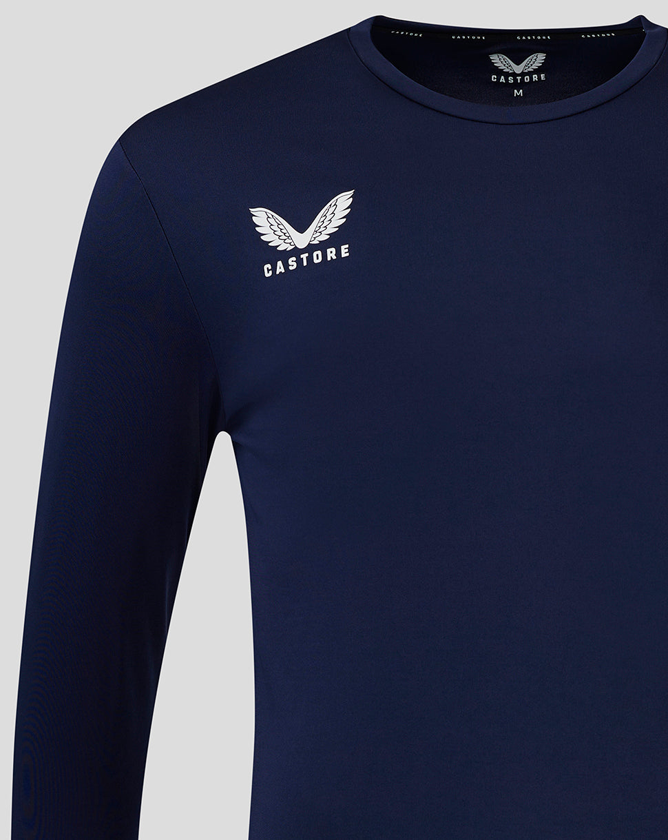 Close up of navy long sleeve training shirt showing the Castore wing logo on the left chest.