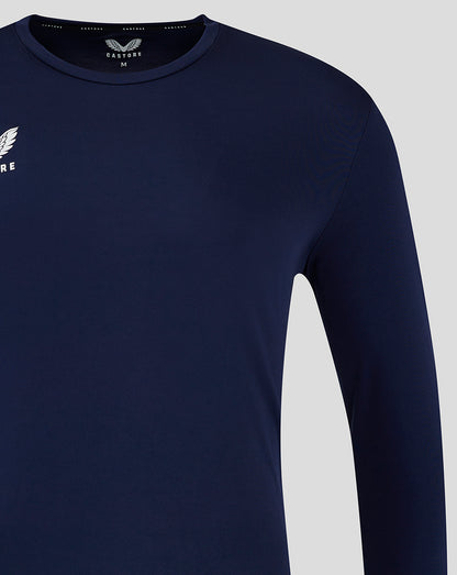 Detail of navy training shirt focusing on the shoulder and sleeve seam.