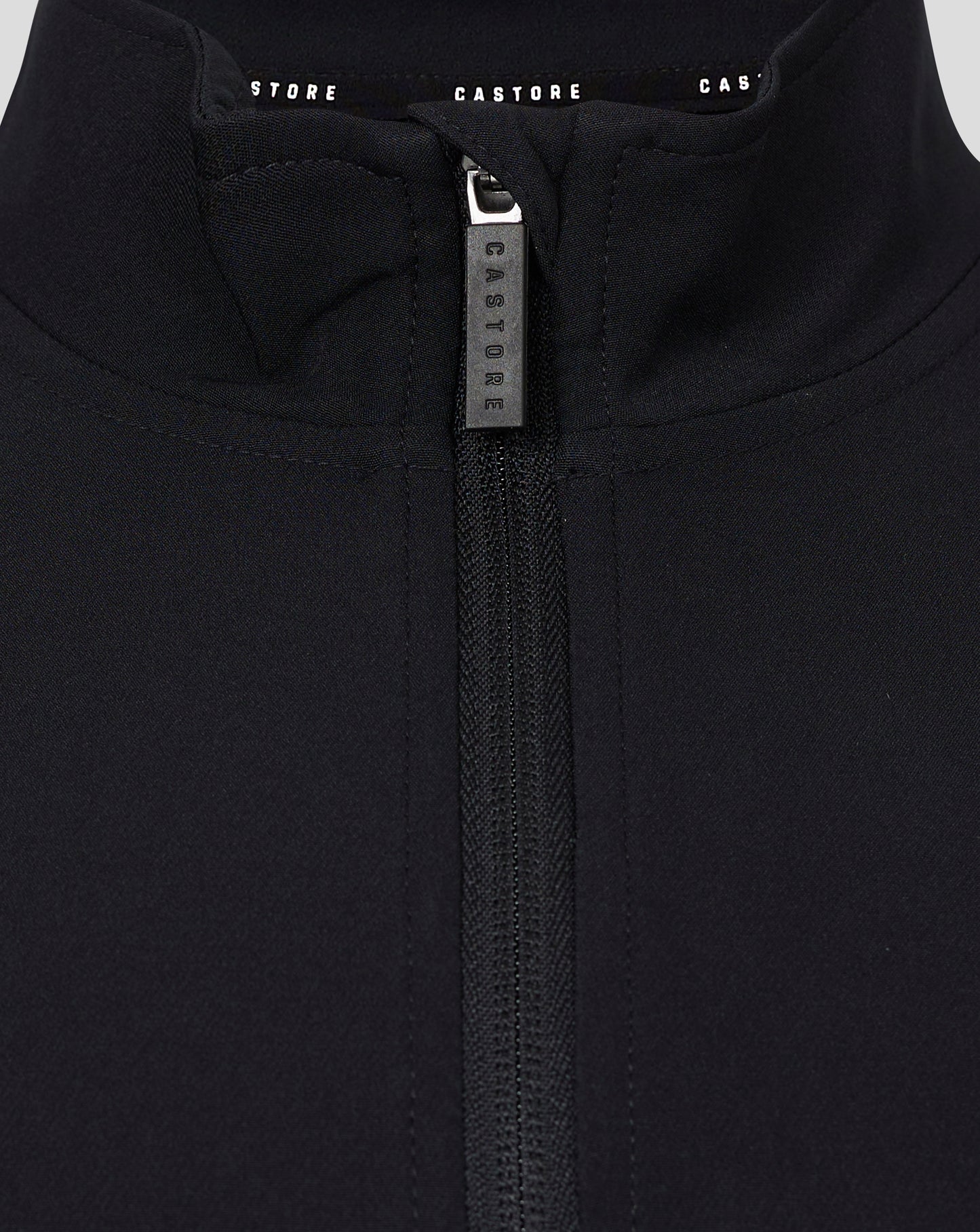 Close-up of the zipper at the collar on a black Castore track jacket