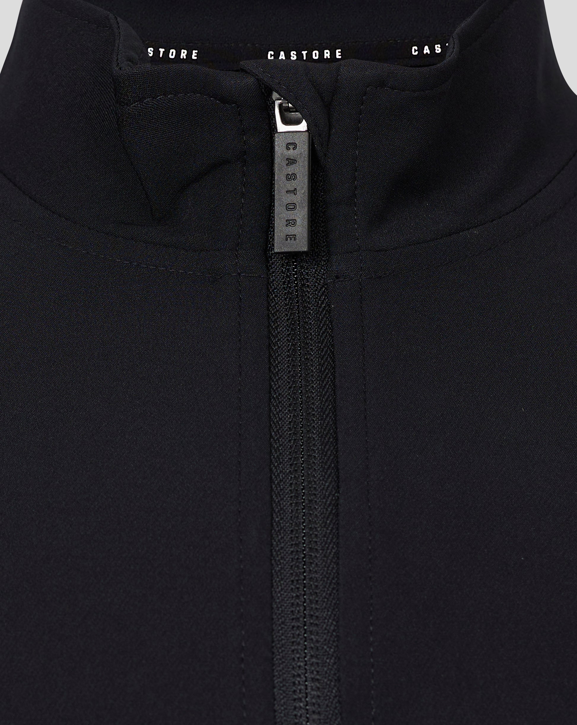 Close-up of the zipper at the collar on a black Castore track jacket