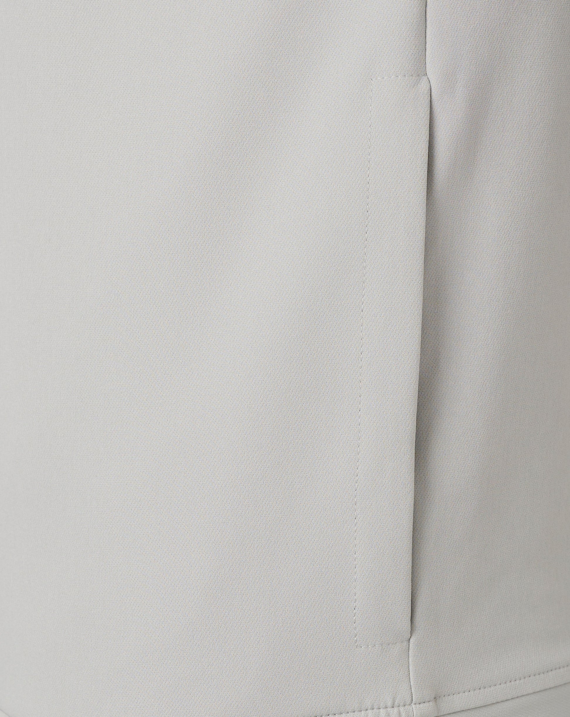 Center front zipper and neck seam on a light grey track jacket.