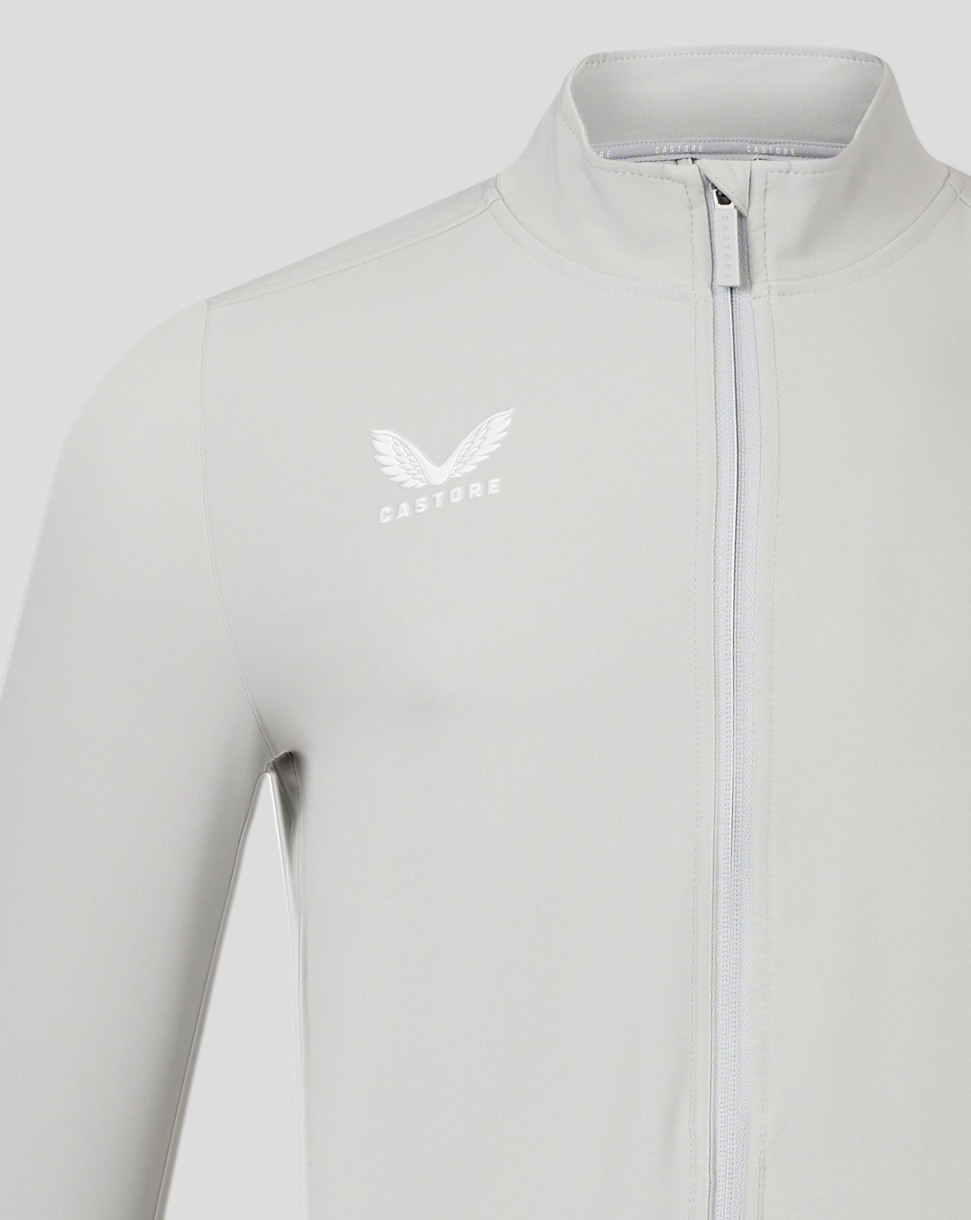 Light gray track jacket with funnel neck and full zip showcasing Castore logo on the chest.