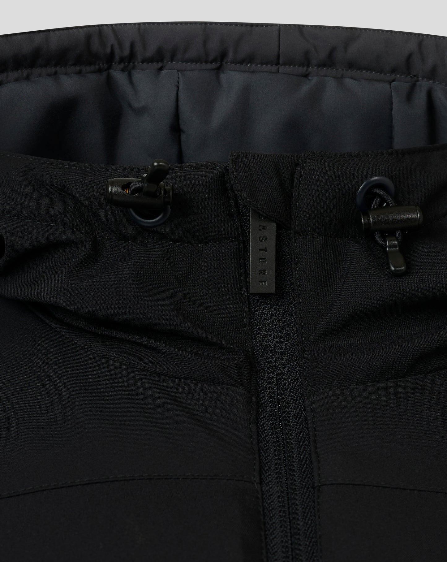 Close up of the jacket waist area with front zipper and adjustable drawcords